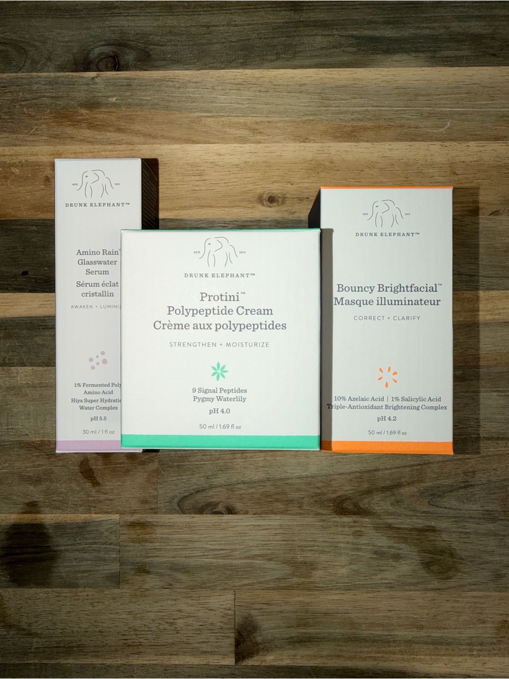 Drunk Elephant Skincare Trio in White with Mint and Orange Accents